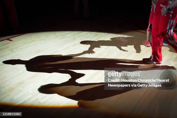 Houston Rockets shooting guard James Anderson casts a shadow on the floor during pre game introductions before an NBA basketball game against the...