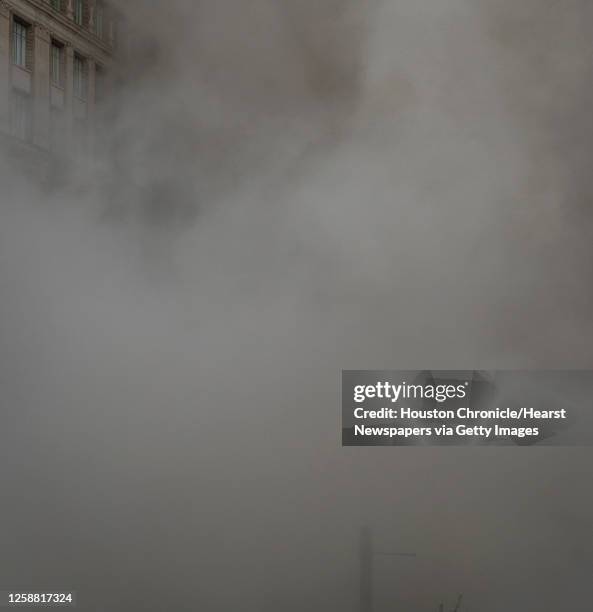 Series of explosive charges brings down the landmark former Macy's department store building in downtown Houston on Sunday, Sept. 22, 2013. Many...
