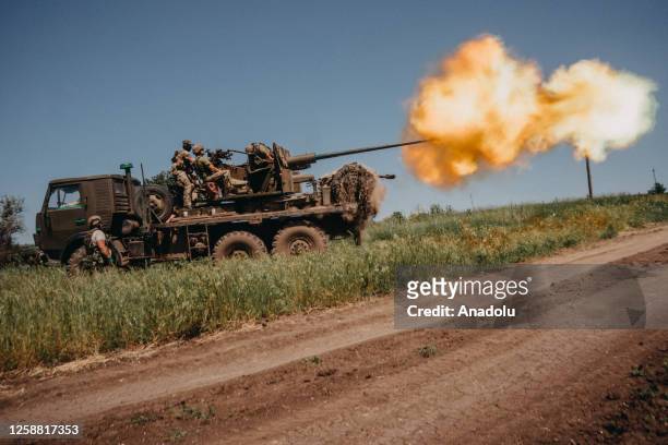 Ukrainian soldiers from the 60th Battalion of Territorial Defense, are shooting rounds into Russian positions with an S60 anti-aircraft canon placed...