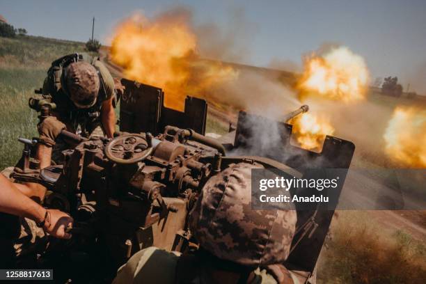 Ukrainian soldiers from the 60th Battalion of Territorial Defense, are shooting rounds into Russian positions with an S60 anti-aircraft canon placed...