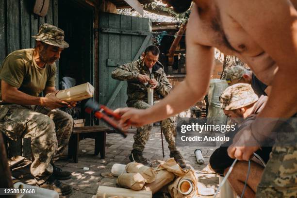 Ukrainian soldiers from the 60th Battalion of Territorial Defense are preparing artillery shells at their base in Donbas, Ukraine on June 19, 2023.