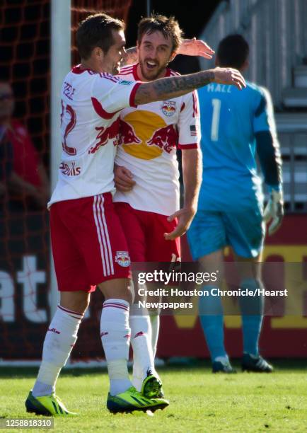 New York Red Bulls midfielder Eric Alexander celebrates with midfielder Jonny Steele after scoring past Houston Dynamo goalkeeper Tally Hall during...