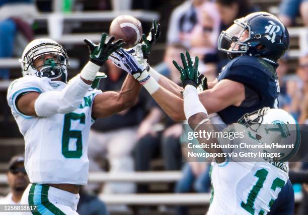 Tulane cornerback Lorenzo Doss and cornerback Derrick Strozier break up a pass intended for Rice wide receiver Dennis Parks during the second quarter...