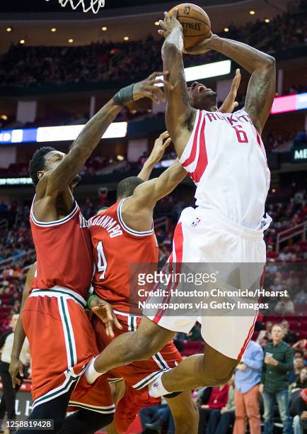 Houston Rockets power forward Terrence Jones is defended by Milwaukee Bucks center Larry Sanders and guard Giannis Antetokounmpo as he puts up a shot...