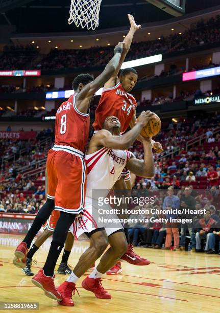 Houston Rockets power forward Terrence Jones is defended by Milwaukee Bucks center Larry Sanders and guard Giannis Antetokounmpo as he puts up a shot...