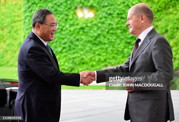 German Chancellor Olaf Scholz shakes hands with China's Premier Li Qiang as he arrives at the Chancellery in Berlin on June 19, 2023. China's Premier...