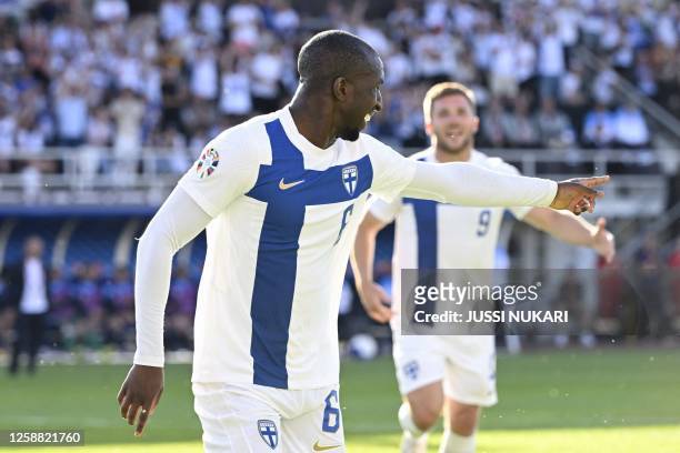 Finland's midfielder Glen Kamara celebrates scoring the opening goal with his teammates during the UEFA Euro 2024 group H qualification football...