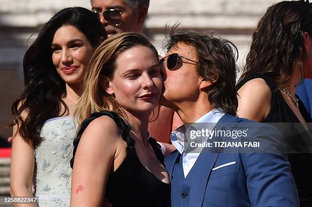 Producer and actor Tom Cruise kisses on the cheek Swedish actress Rebecca Ferguson as they pose on the Spanish Steps ahead of the premiere of...