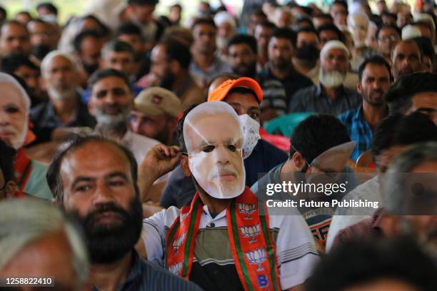 June 17 Srinagar Kashmir, India: A supporter of the rightwing Bharatiya Janata Party wears a mask of Indian Prime Minister Narendra Modi as he...