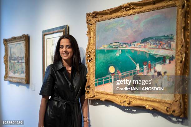 French actress Anouchka Delon poses next to the work of art titled "La Baie de Saint-Adresse" by French painter Raoul Dufy, during the media...