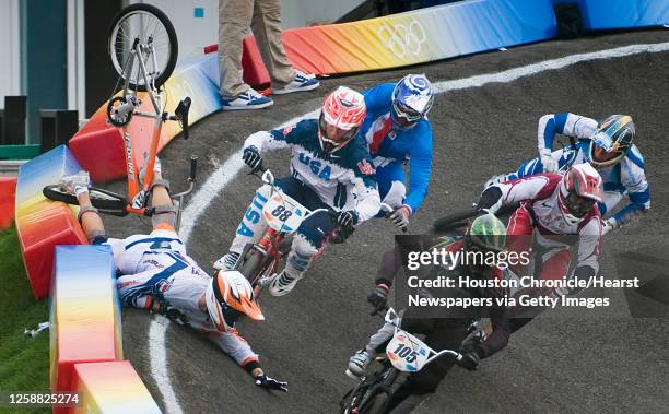 Raymon van der Biezen of The Netherlands crashes right in front of Kyle Bennett of Conroe, Texas, on a turn during the quarterfinals of BMX cycling...