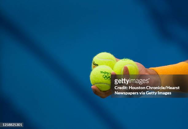 Rafael Nadal of Spain hold three Olympic logo tennis balls in his hand before serving during the men's singles tennis gold medal final at the 2008...