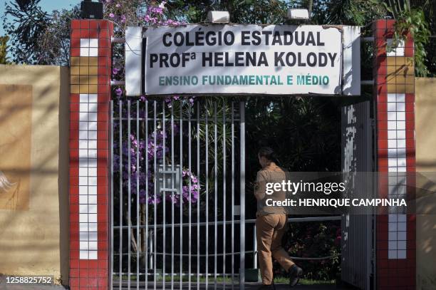 Military Police officers stand guard in the surroundings of the Professora Helena Kolody State School following an armed attack in Cambe, Parana...