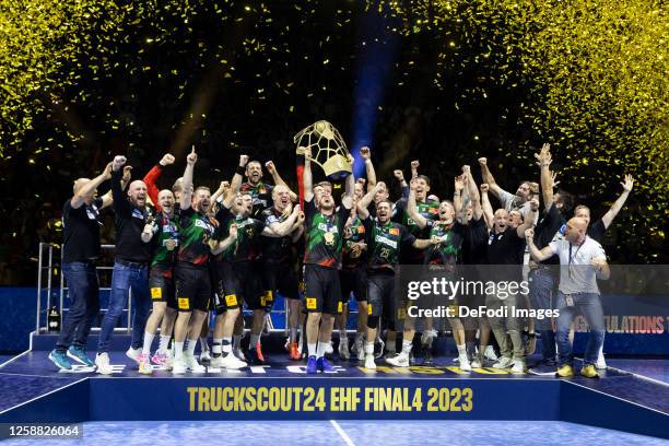 The Magdeburg players celebrate winning the Champions League with the trophy after the EHF FINAL4 Men Champions League final match between SC...