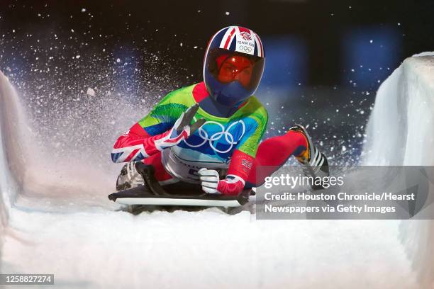 Gold medalist Amy Williams of Great Britain pounds her sled in celebration as she finishes her final run in womens' skeleton at the 2010 Winter...