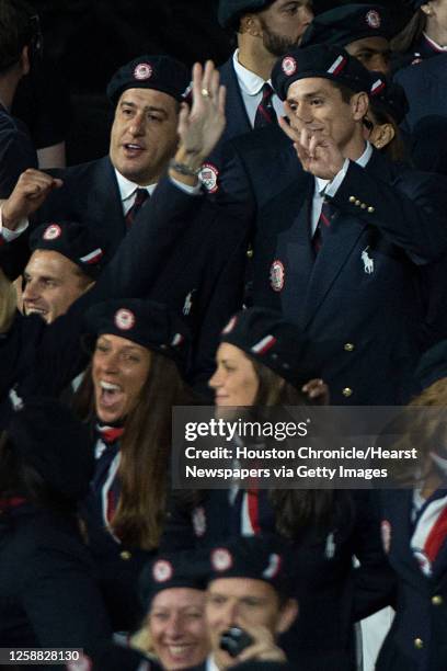 Taekwondo athlete Steven Lopez, top right, and his brother, coach Jean Lopez, wave to the crowd as the USA enters the stadium during the opening...