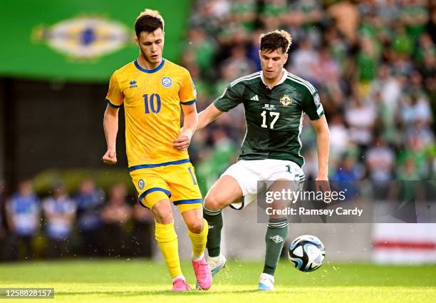 Belfast , United Kingdom - 19 June 2023; Maxim Samorodov of Kazakhstan in action against Paddy McNair of Northern Ireland during the UEFA EURO 2024...