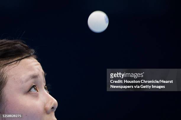 Ariel Hsing of San Jose, Calif, keeps her eye on the ball as she serves during her women's singles third round table tennis match against Li Xiaoxia...