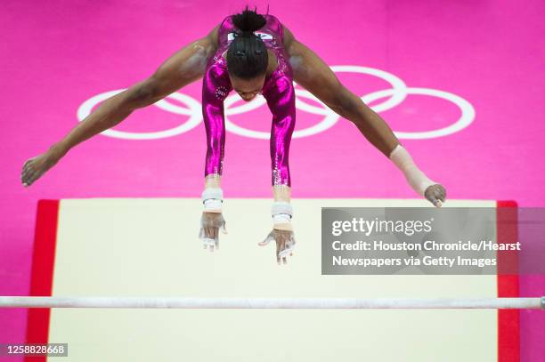 Gymnast Gabrielle Douglas performs on the uneven bars during the women's gymnastics individual all-around final at the 2012 London Olympics on...