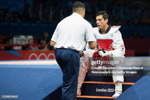 Steven Lopez of the USA gets direction from his coach Jean Lopez before the final round of his bout against Azerbaijan's Ramin Azizov in the men's...