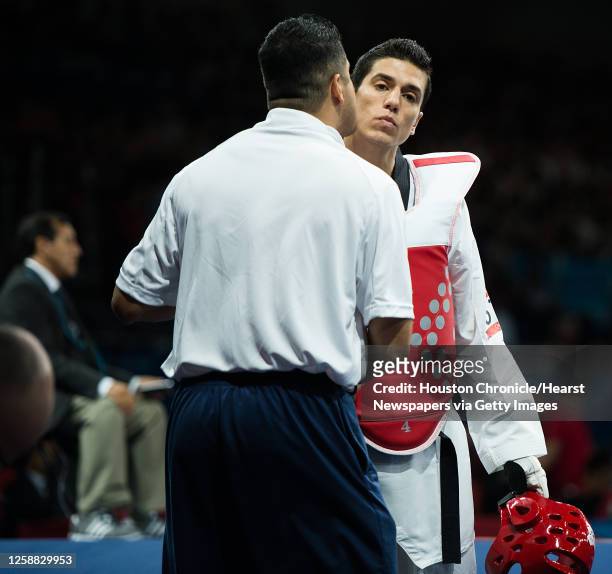 Steven Lopez of the USA gets a kiss from his coach, and brother, Jean Lopez before fighting Azerbaijan's Ramin Azizov in the men's 80-kg taekwondo...