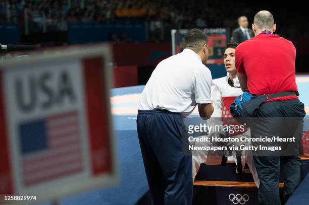 Steven Lopez of the USA gets direction from his coach Jean Lopez before the final round of his bout against Azerbaijan's Ramin Azizov in the men's...