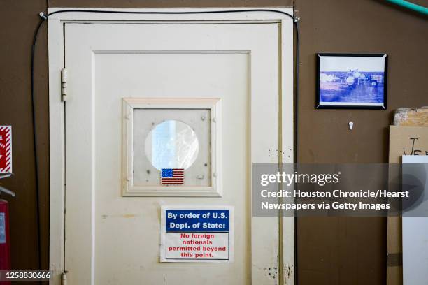 Sign on a doorway warns of International Traffic in Arms Regulations restrictions in the XCOR Aerospace hangar at the Mojave Air and Space Port on...