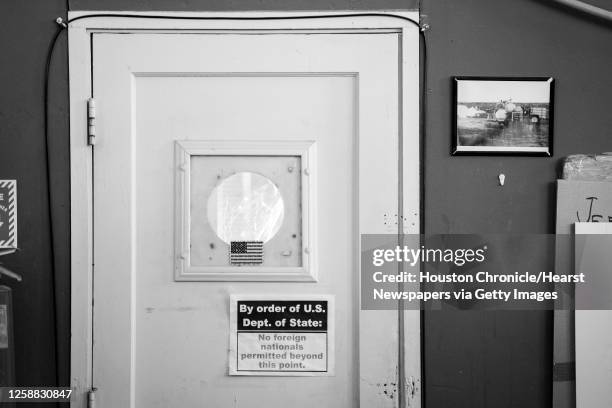 Sign on a doorway warns of International Traffic in Arms Regulations restrictions in the XCOR Aerospace hangar at the Mojave Air and Space Port on...