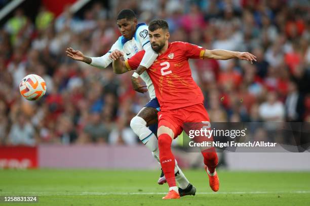 Marcus Rashford of England and Egzon Bejtulai of North Macedonia challenge during the UEFA EURO 2024 Qualifying Round Group C match between England...