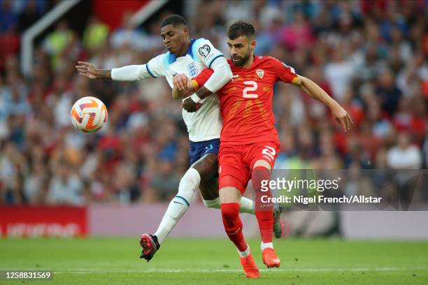 Marcus Rashford of England and Egzon Bejtulai of North Macedonia challenge during the UEFA EURO 2024 Qualifying Round Group C match between England...