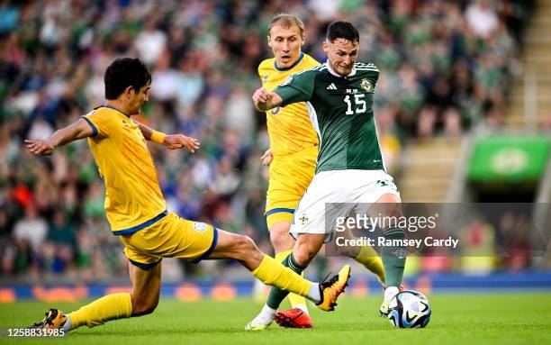 Belfast , United Kingdom - 19 June 2023; Jordan Thompson of Northern Ireland is tackled by Marat Bystrov of Kazakhstan during the UEFA EURO 2024...