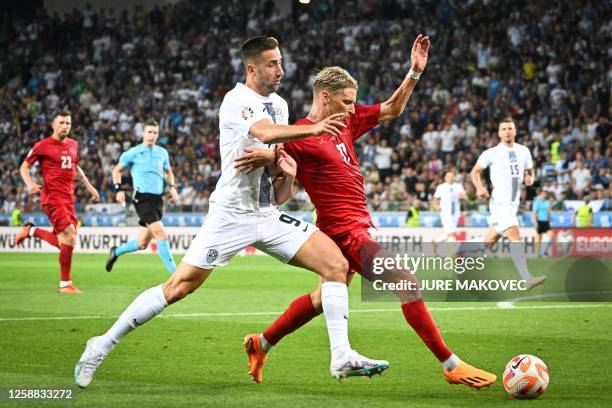 Slovenia's forward Andraz Sporar fights for the ball with Denmark's defender Jens Stryger during the Group H Euro 2024 Qualifying match between...