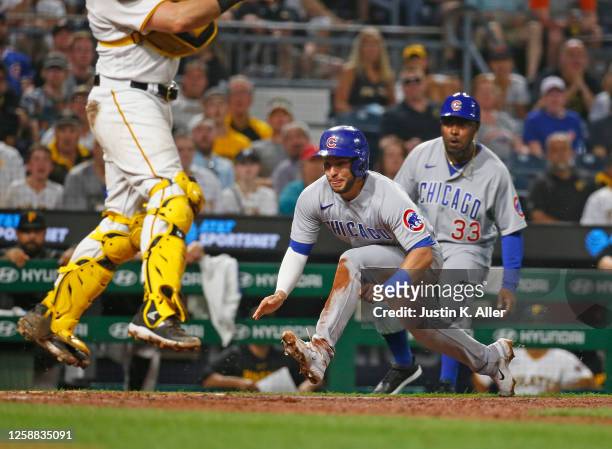 Nick Madrigal of the Chicago Cubs slides in safe in the seventh inning on an RBI single against the Pittsburgh Pirates at PNC Park on June 19, 2023...