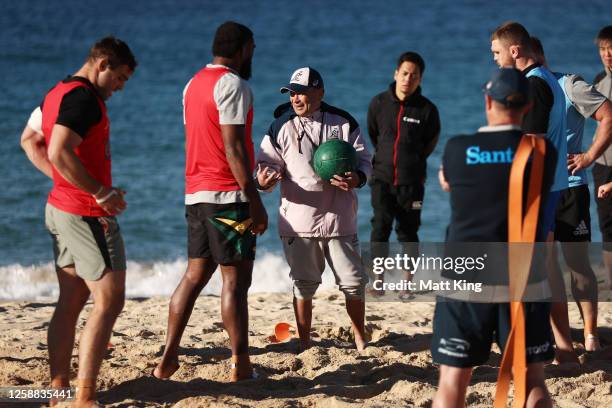 Wallabies head coach Eddie Jones talks to players during an Australian Wallabies training session at Coogee Beach on June 20, 2023 in Sydney,...