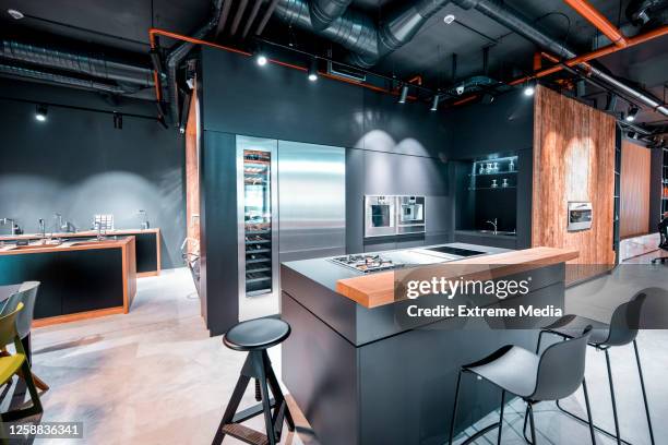 contemporary kitchen design with luxurious equipment and appliances in a kitchen equipment store display space - showroom stock pictures, royalty-free photos & images