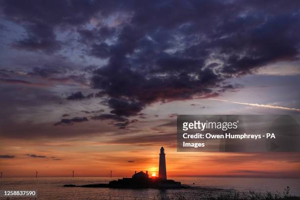 The sunrises at 04.25am at St Mary's Lighthouse in Whitley Bay, on the North East coast of England, the day before Summer Solstice - the longest day...