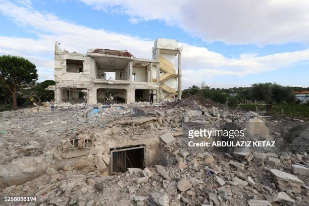 Man walks on the rubble of a damaged building following reported Russian air raids on the outskirts of Syria's rebel-held northwestern city of Idlib,...