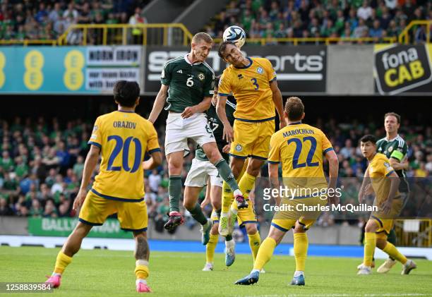 George Saville of Northern Ireland and Nuraly Alip of Kazakhstan battle for possession during the UEFA EURO 2024 qualifying round group D match...