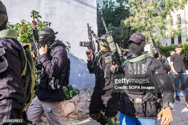 Gunmen take part in the funeral of one of the five Palestinians who were killed during a bloody raid at Jenin refugee camp in the northern West Bank....