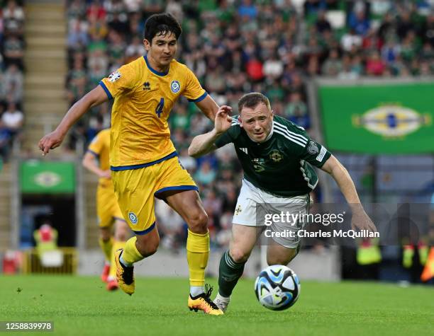 Shane Lavery of Northern Ireland is fouled by Marat Bystrov of Kazakhstan during the UEFA EURO 2024 qualifying round group D match between Northern...