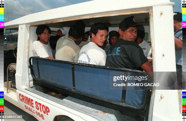 Arrested Vietnamese fishermen are escorted by Philippine police for a medical check at a local hospital as authorities prepares decision on their...