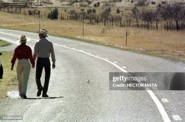 Two supporters of the separatist group Republic of Texas leader Rick McLaren walk past the Davis Mountain gate roadblock following a police briefing...