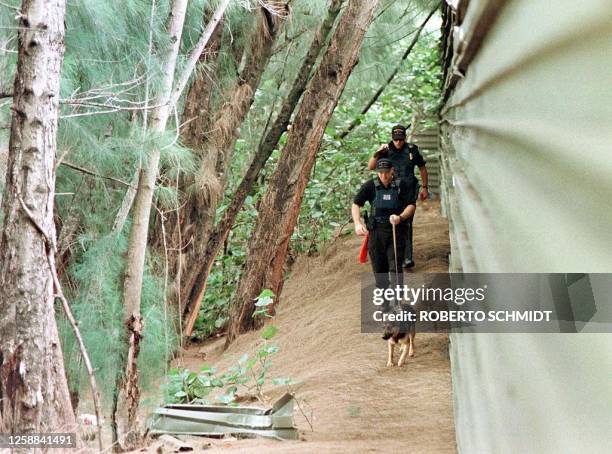 Miami Springs police K-9 unit searches 17 July a canal area near the home of an unidentified medical doctor who was found murdered inside his home in...