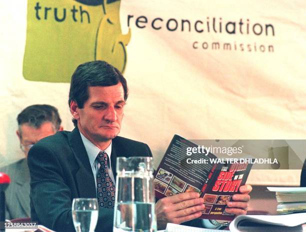 Wagner legal representative of Adriaan Vlok, former South African Minister of Police, browses through a book, here at the Truth and Reconciliation...