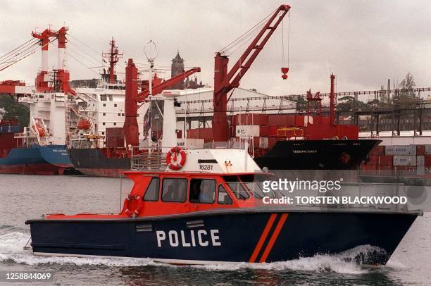 Police launch patrols the shipping wharves of Sydney Harbour 02 April after the Australian Workers Union threatened a general strike throughout...