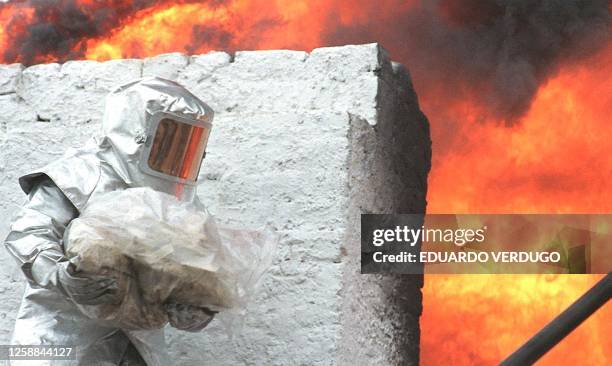 Member of Peru's drug enforcement police prepares to throw a bag full of drugs into an incinerator, 17 April in Lima. Some 6,270 kilos of drugs,...