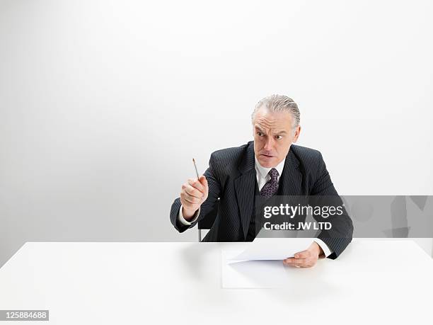 angry businessman at desk  - bossy fotografías e imágenes de stock