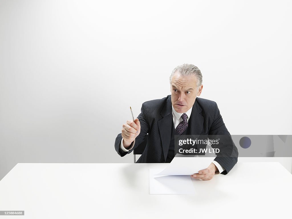 Angry businessman at desk 