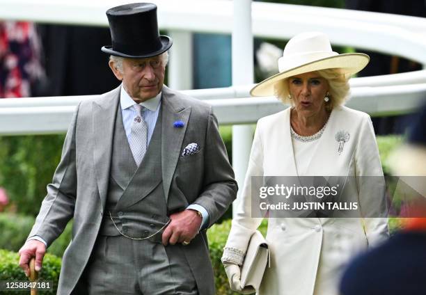 Britain's King Charles III and Britain's Queen Camilla arrive to attend the races on the first day of the Royal Ascot horse racing meeting, in Ascot,...