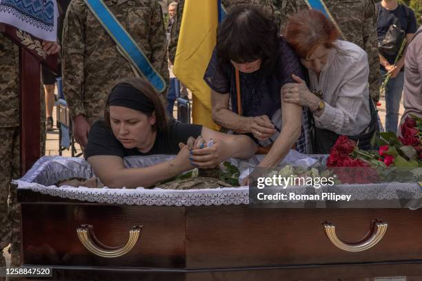 Wife Anastasiia , and mother Nataliia together with others mourn over the coffin of Ivan Shulha, a Ukrainian serviceman, who was killed fighting...